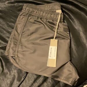 Essential fear of god running shorts nylon in color iron